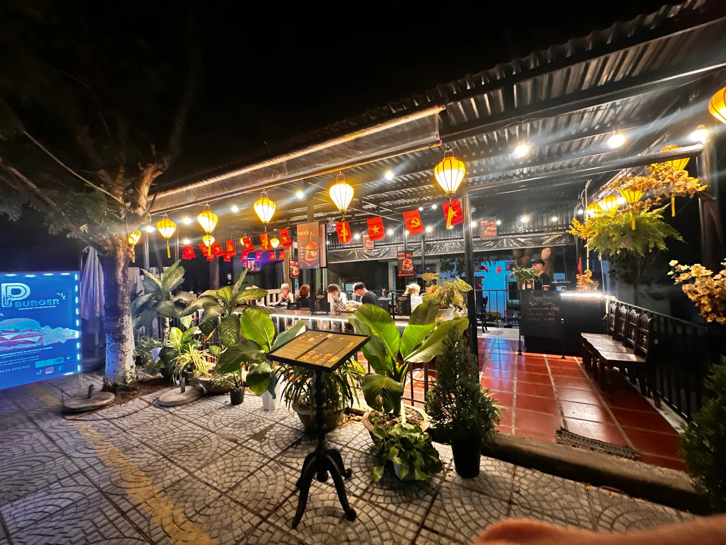 P Burger terrace at night with lanterns and string lights