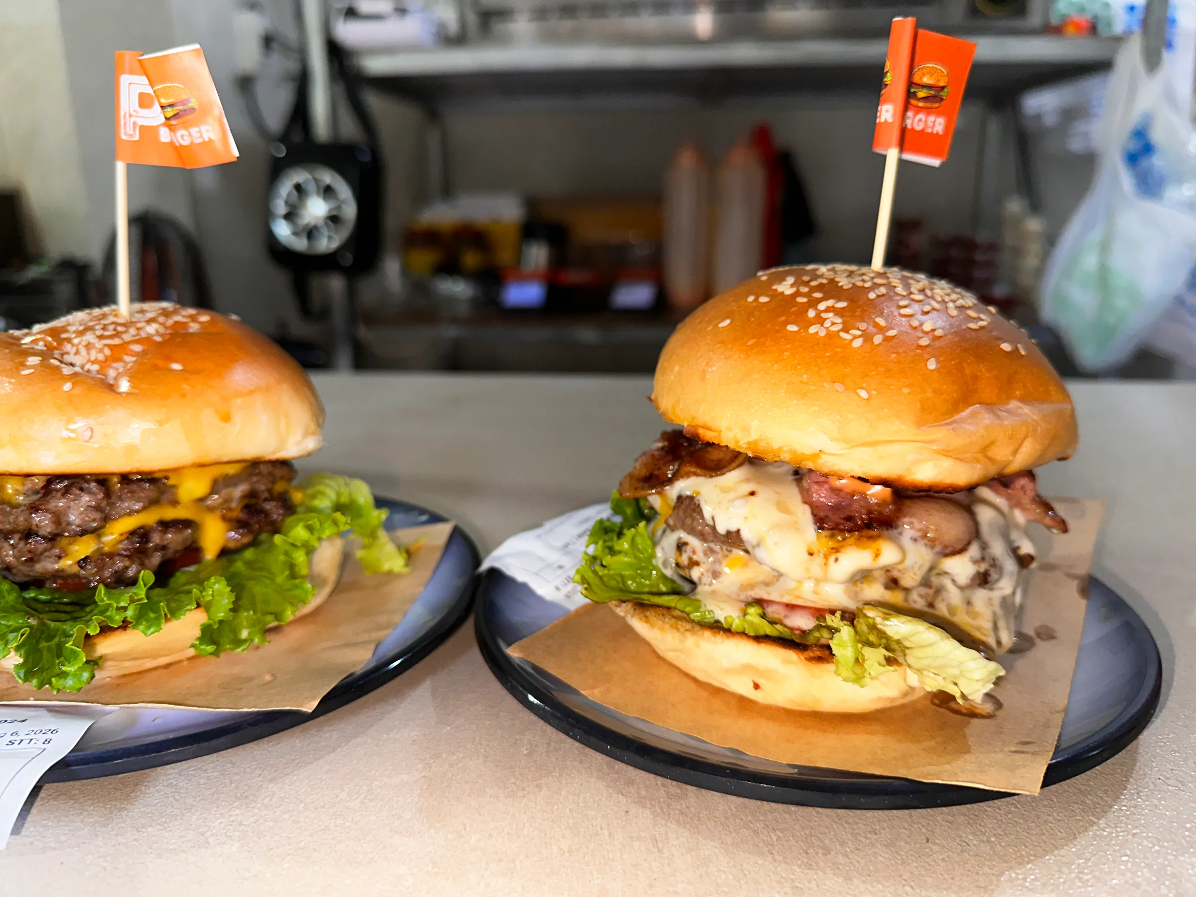 Two burgers with P flags fresh from the kitchen